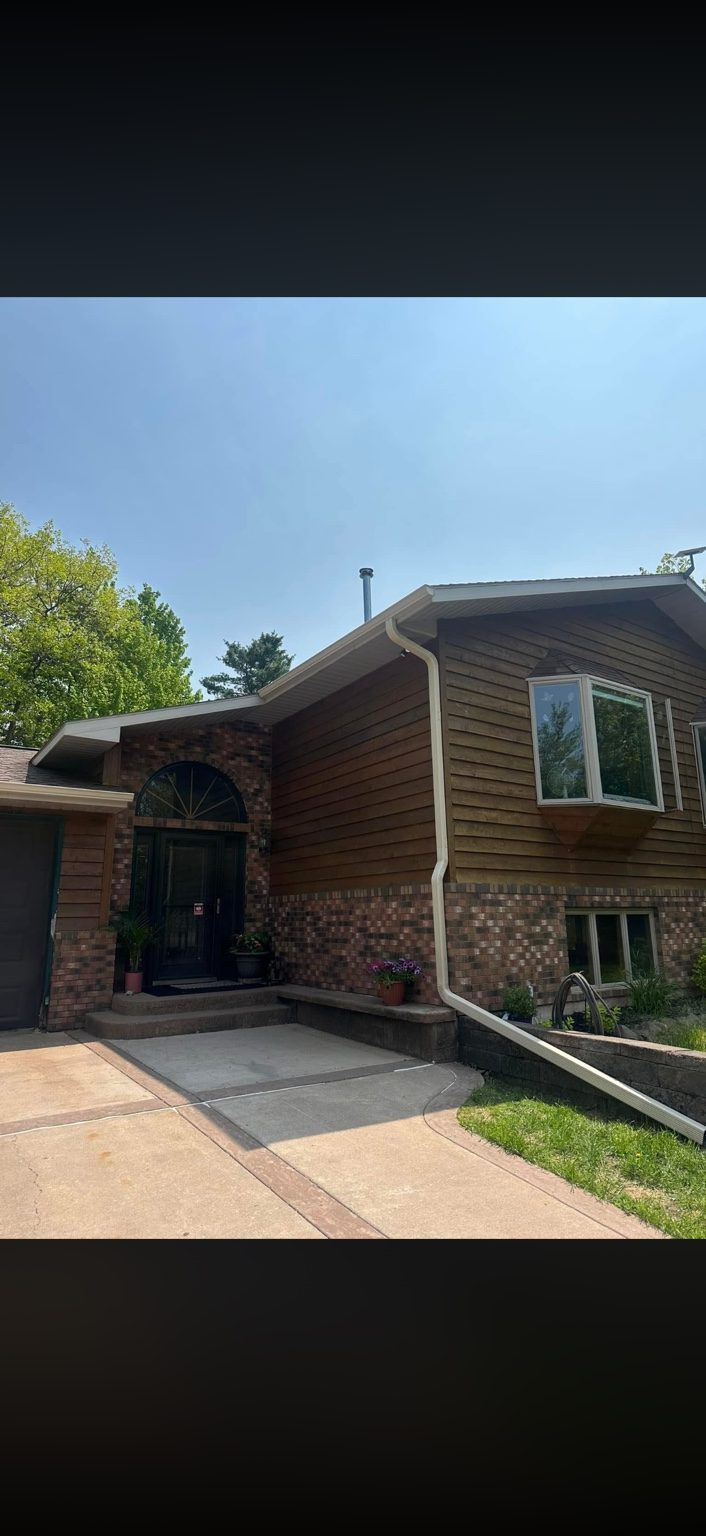 White downspout on brown home