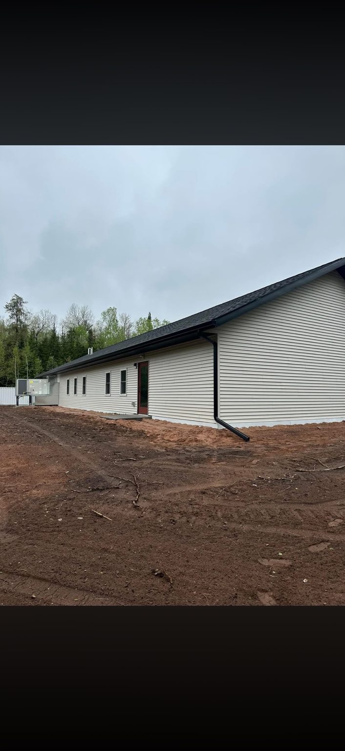 Long black gutter install on building