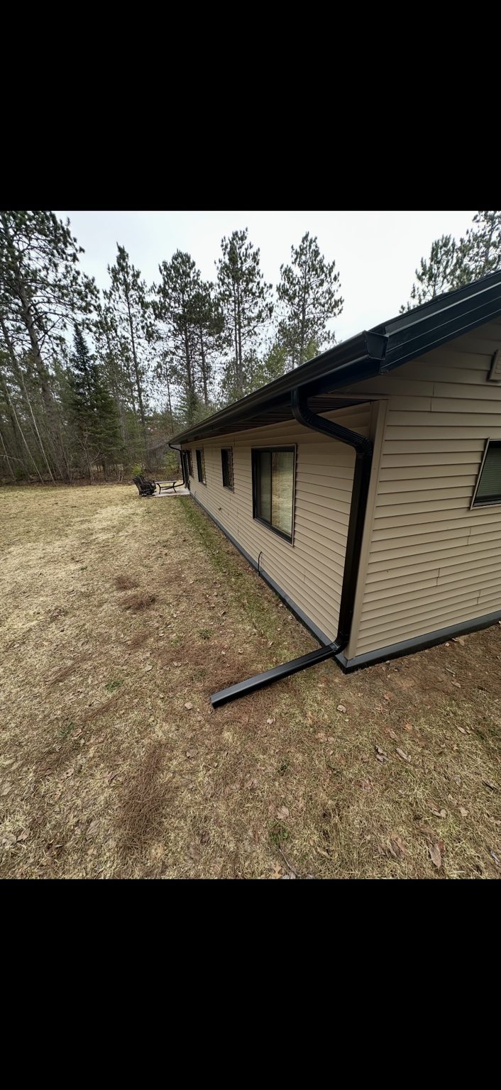 Black gutters on tan home